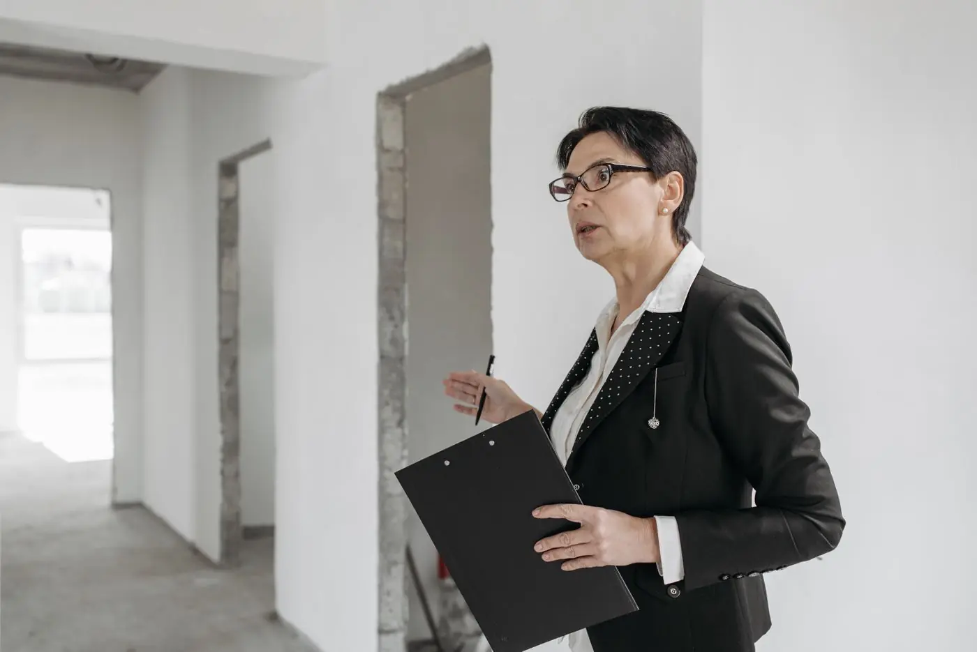 A property professional conducting a structured site handover inspection.