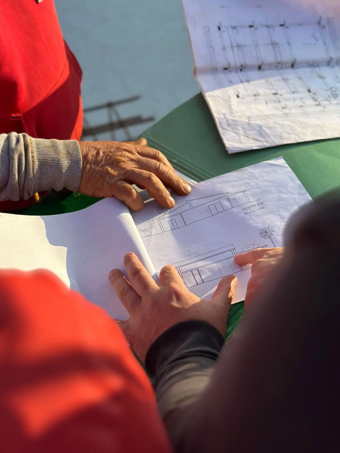 Team members reviewing project drawings together.