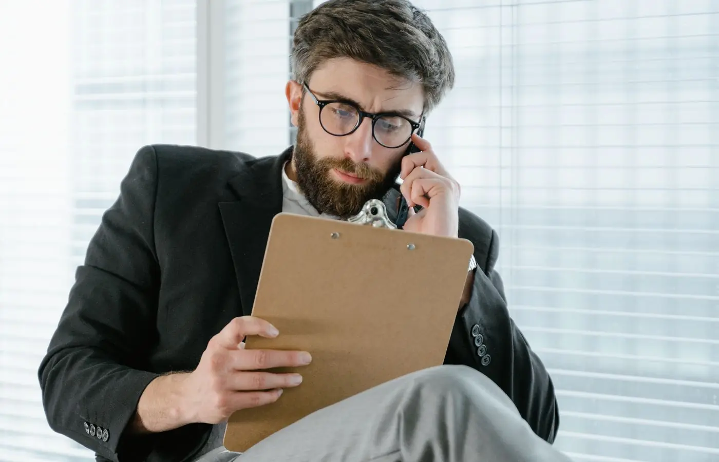 An insurance professional reviewing claim details on a clipboard.