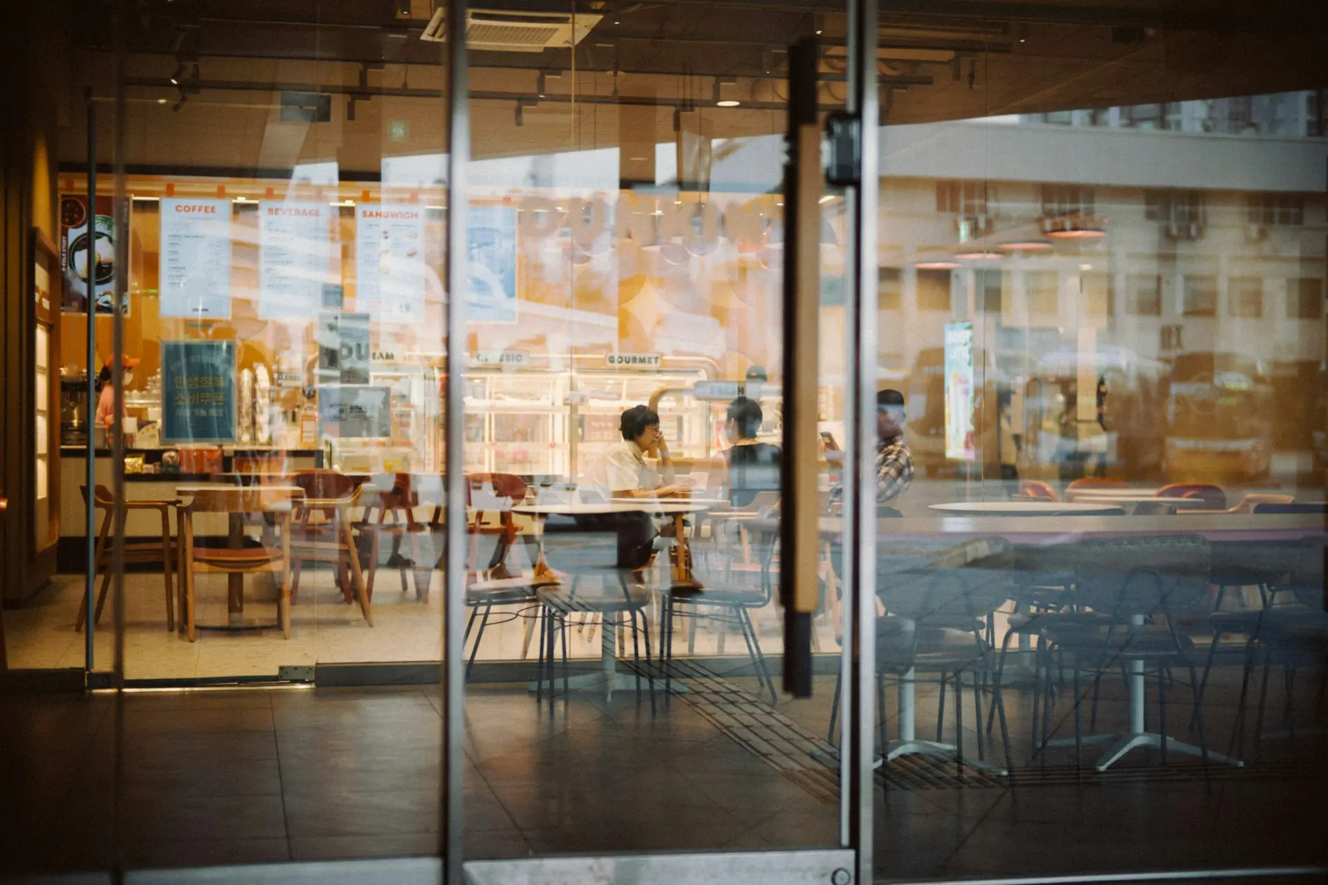 A café shopfront with glazed doors and aluminium-framed frontage panels.