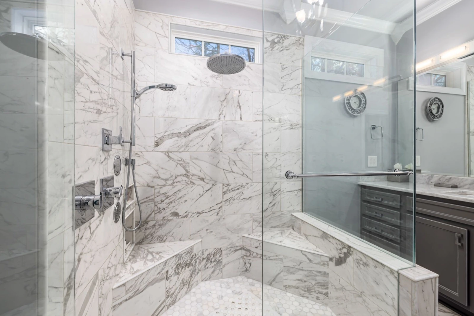 A contemporary bathroom with a clear glass shower enclosure.
