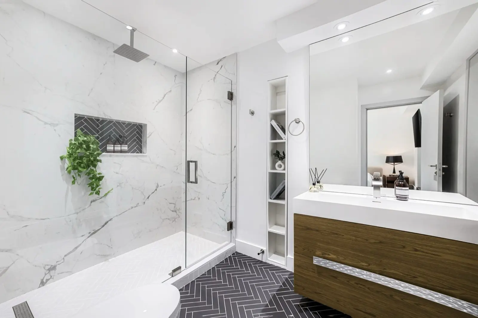 A bathroom with a frameless glass shower enclosure.
